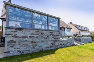 Stylish home extension overlooking a patio in Tintagel